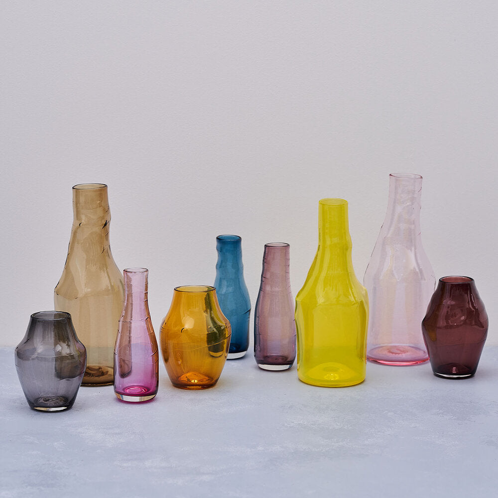 A group of glass flower vases