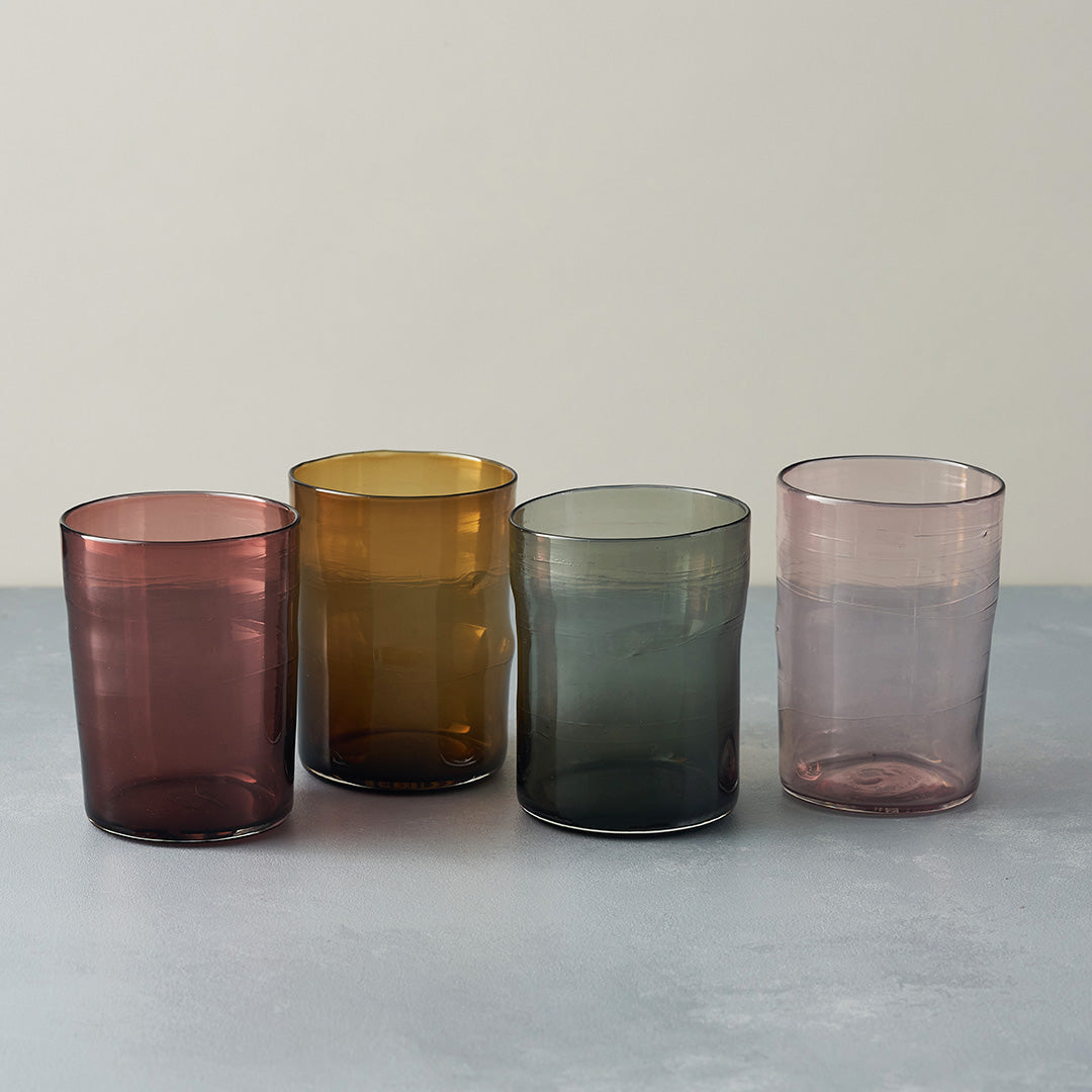 four coloured water glasses