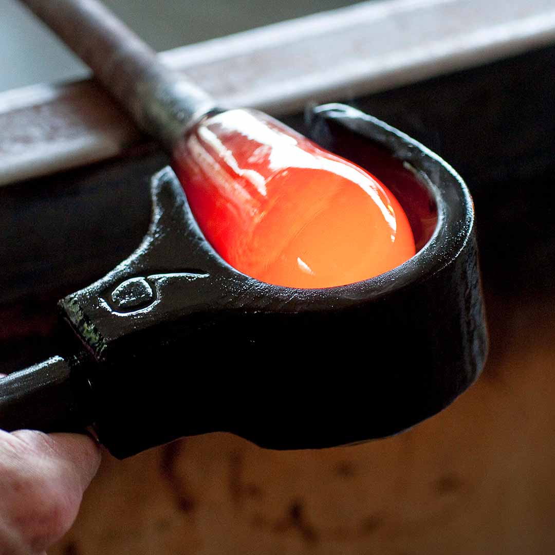 Hot glass being shaped to make glassware