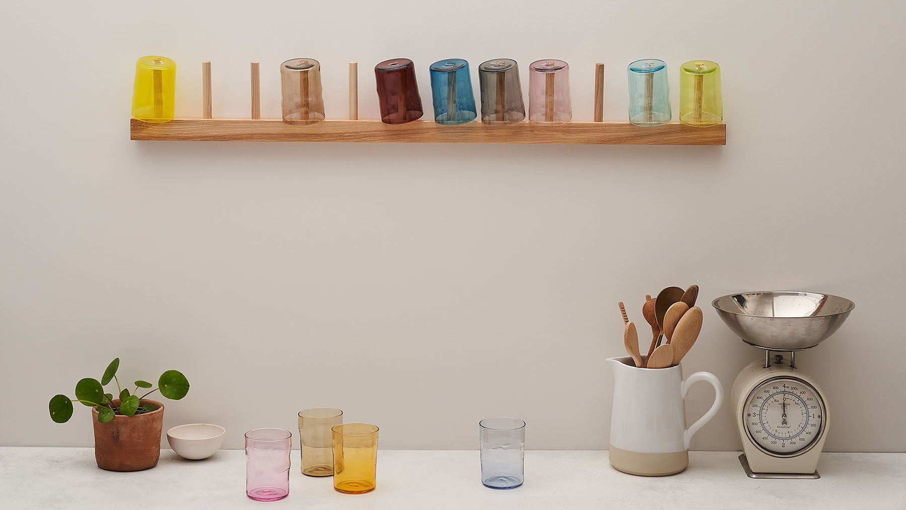 Glass Coloured Tumblers on a wooden wall rack