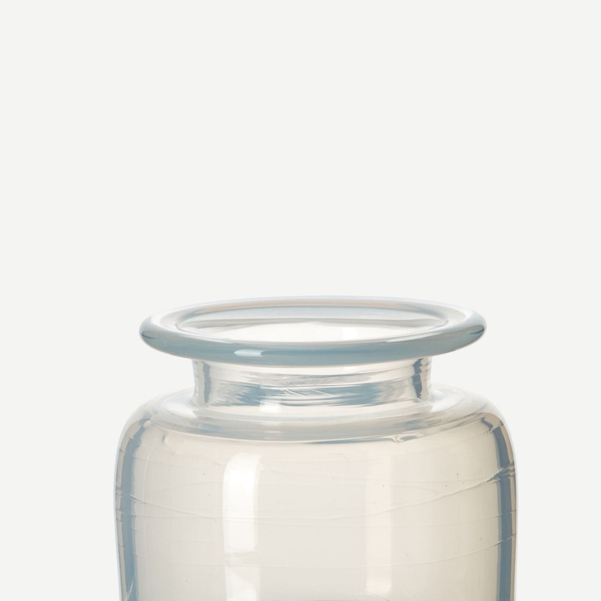 detail of handblown white glass jar vase