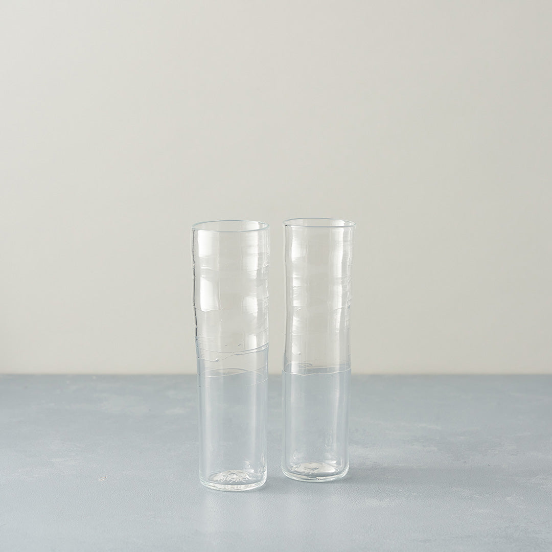 a pair of clear glass champagne flute