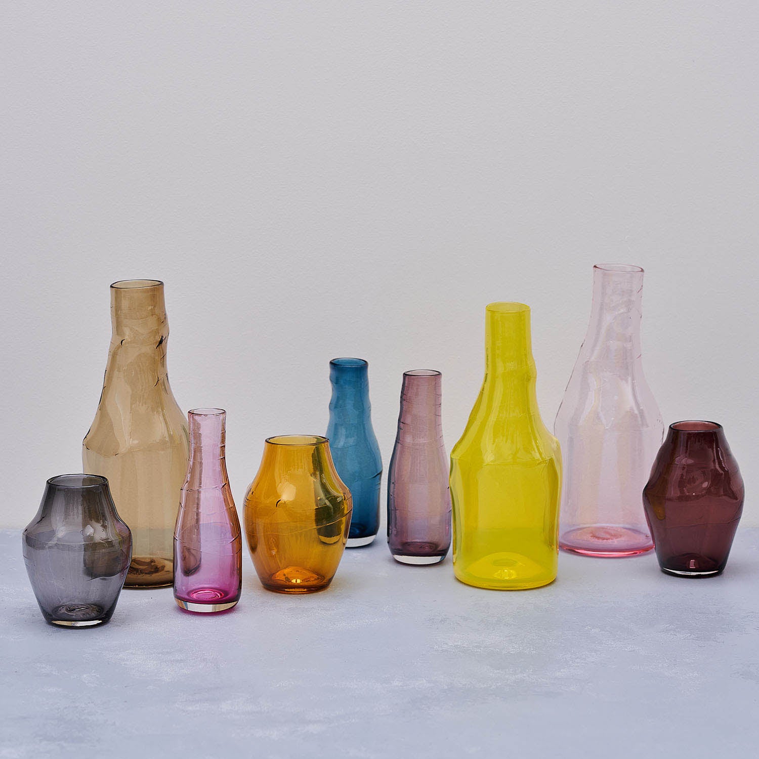 a collection of coloured glass vases